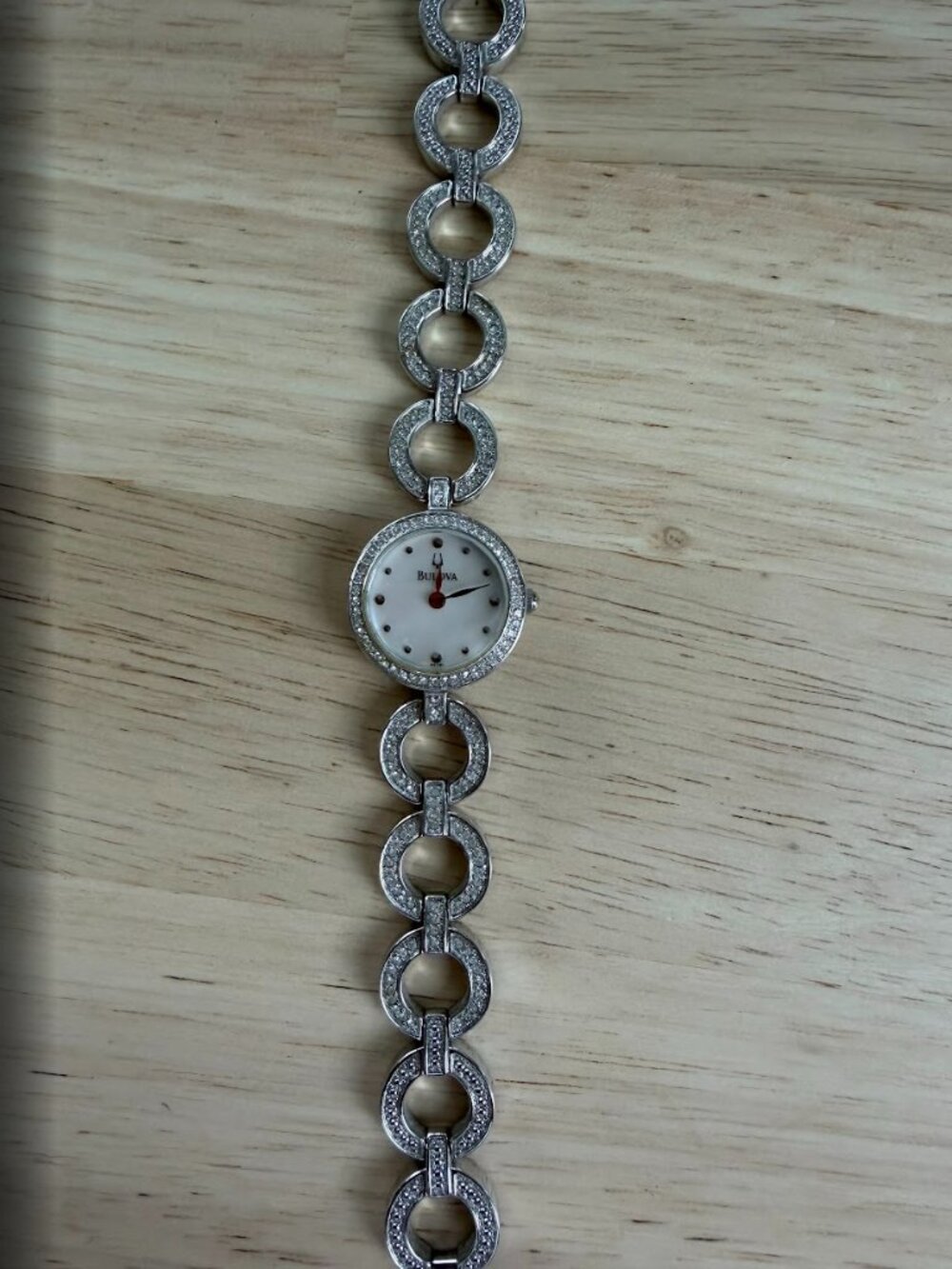 Bulova's ladies' watch with crystal circle link bracelet and a mother-of-pearl